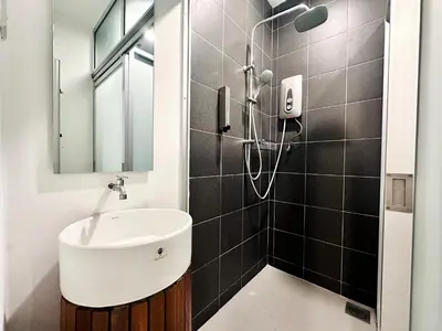 a bathroom with a sink and a shower at C Y C Heritage Hotel in George Town