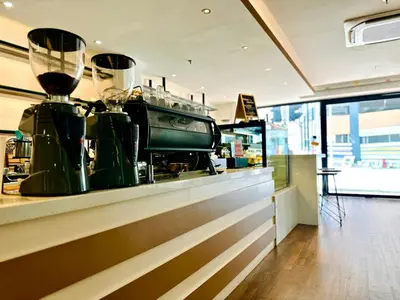 a counter in a store with a coffee machine on it at C Y C Heritage Hotel in George Town