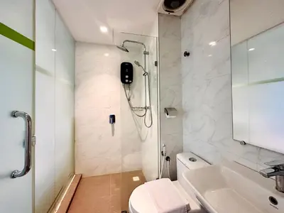 a bathroom with a shower and a toilet and a sink at C Y C Heritage Hotel in George Town