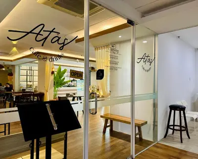 a store window with a sign that says airify at C Y C Heritage Hotel in George Town