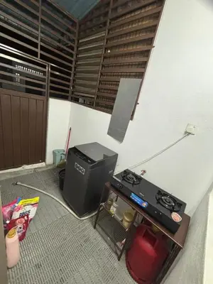 a room with a stove and a printer in it at Nameera Stay Bandar Universiti Seri Iskandar in Seri Iskandar