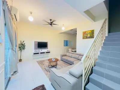 a living room with a couch and a tv at Nameera Stay Bandar Universiti Seri Iskandar in Seri Iskandar