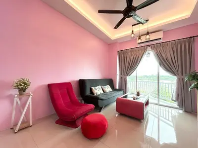 a living room with pink walls and a red chair at Sky Garden Ipoh Comfortable Homestay 6-7pax SY27 in Chemor