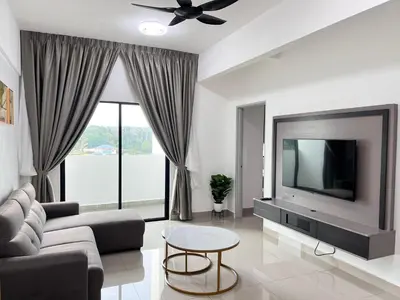 a living room with a couch and a tv at FY Perumahan Makmur TR Jaya Tanah Rata in Tanah Rata