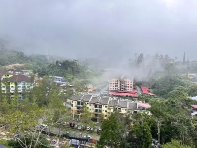 a city with buildings on a hill with trees at FY Perumahan Makmur TR Jaya Tanah Rata in Tanah Rata