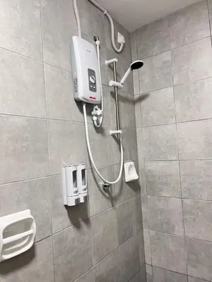a shower in a bathroom with a soap dispenser at FY Perumahan Makmur TR Jaya Tanah Rata in Tanah Rata