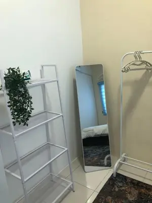 a room with a mirror and a shelf with a plant at DQis Nest Casa Apartment in Chemor