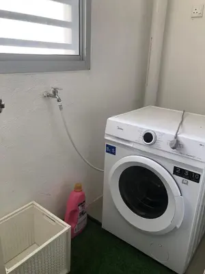 a washing machine in a room with a window at DQis Nest Casa Apartment in Chemor