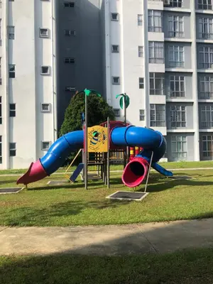 a playground in front of a tall building at DQis Nest Casa Apartment in Chemor