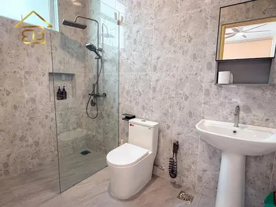 a bathroom with a shower and a toilet and a sink at Aesthetic Muji Pool Villa in Ipoh 5BR 24Pax Karaoke Snooker Air hockey in Tambun