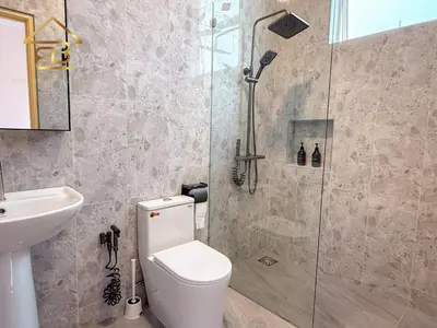 a bathroom with a shower and a toilet and a sink at Aesthetic Muji Pool Villa in Ipoh 5BR 24Pax Karaoke Snooker Air hockey in Tambun