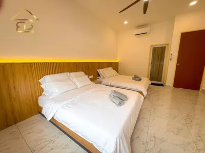 two beds in a room with white sheets at Aesthetic Muji Pool Villa in Ipoh 5BR 24Pax Karaoke Snooker Air hockey in Tambun