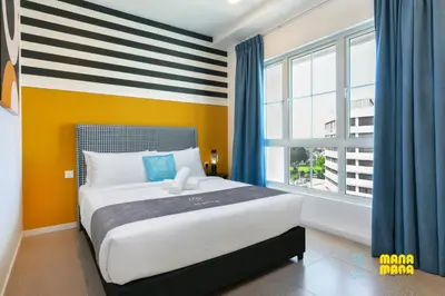 a bedroom with a bed and a large window at Stallionz by MyKey in Ipoh