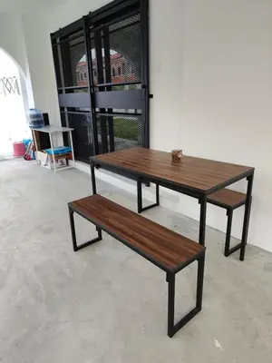 a wooden table and a bench in a room at Arjuna Homestay - Batu Gajah in Batu Gajah