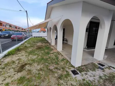 a building with a yard next to a parking lot at Arjuna Homestay - Batu Gajah in Batu Gajah