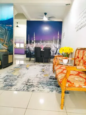 a living room with a table and a couch at Homestay Ustaz in Batu Gajah