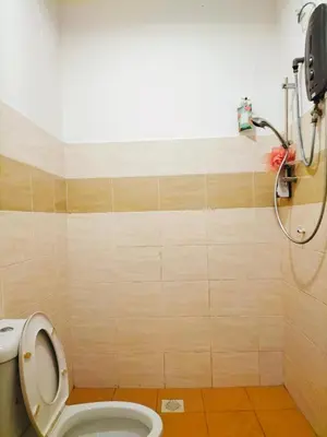 a bathroom with a toilet and a shower at Homestay Ustaz in Batu Gajah