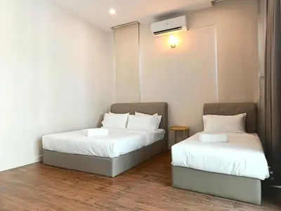 two beds with white sheets in a room at myRoom at 11, Jalan Adams Georgetown in George Town