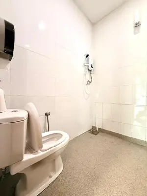 a bathroom with a toilet and a phone on the wall at myRoom at 11, Jalan Adams Georgetown in George Town