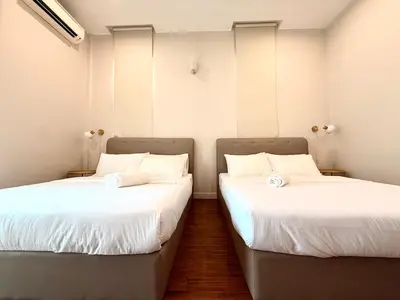 two beds sitting next to each other in a room at myRoom at 11, Jalan Adams Georgetown in George Town