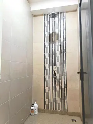 a shower with a glass door in a bathroom at myRoom at 11, Jalan Adams Georgetown in George Town