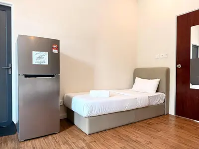 a small room with a bed and a refrigerator at myRoom at 11, Jalan Adams Georgetown in George Town