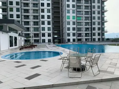 a patio with a table and chairs next to a pool at Erra Homestay Casa Meru Ipoh in Ipoh
