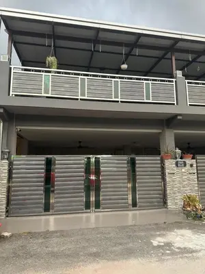 a house with a garage with a metal gate at MM Homestay 80 in Kamunting