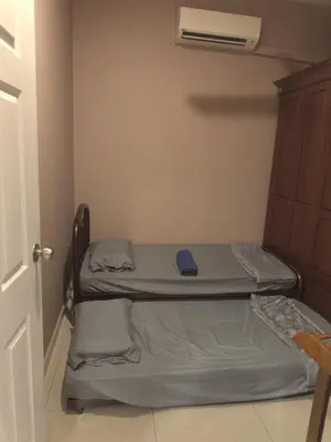 two beds in a small room with a closet at MM Homestay 80 in Kamunting
