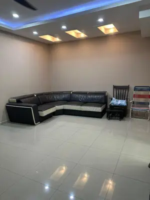 a living room with a black leather couch and chairs at MM Homestay 80 in Kamunting