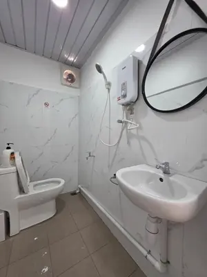 a bathroom with a sink and a mirror and a toilet at Burma Home at Jalan Burma Georgetown Penang in George Town