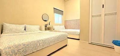 a small bedroom with two beds and a mirror at Burma Home at Jalan Burma Georgetown Penang in George Town