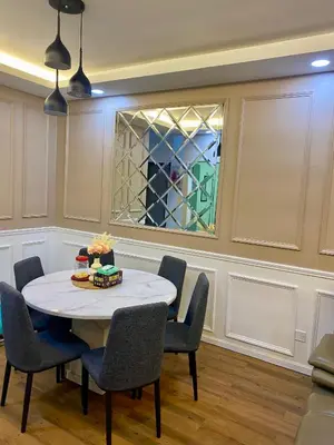 a dining room with a table and chairs and a window at Syahoney Homestay 2 with NETFLIX in Tanah Rata