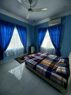 a bedroom with blue walls and a bed with blue curtains at A I HOMESTAY Balik Pulau in Balik Pulau