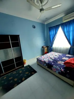 a bedroom with a bed with blue walls and a window at A I HOMESTAY Balik Pulau in Balik Pulau