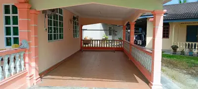a front porch of a house with an orange and yellow at A I HOMESTAY Balik Pulau in Balik Pulau