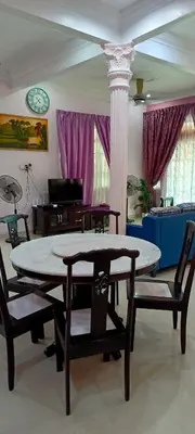 a living room with a table and two chairs at A I HOMESTAY Balik Pulau in Balik Pulau
