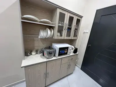 a kitchen with a microwave on a counter at Anjang Pat Kesang Laut Homestay in Gua Sai