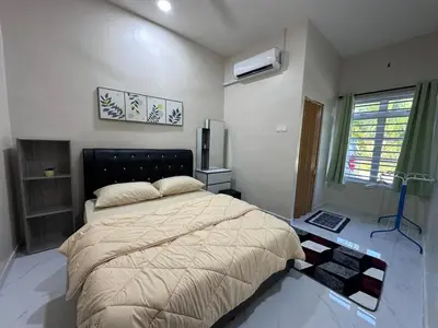 a bedroom with a large bed and a window at Anjang Pat Kesang Laut Homestay in Gua Sai