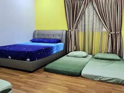 a bedroom with two beds and a window with curtains at Sekinchan Family-style XL Size Homestay in Sekincan