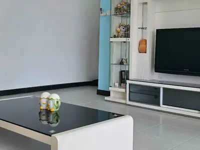 a living room with a tv and a table at Sekinchan Family-style XL Size Homestay in Sekincan