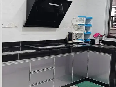 a kitchen with a black counter top with a sink at Sekinchan Family-style XL Size Homestay in Sekincan