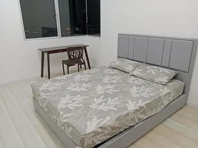 a bedroom with a bed and a table and a chair at Skyline Nest Crystal Creek in Taiping