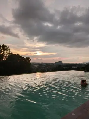 a swimming pool with a person in the water at Skyline Nest Crystal Creek in Taiping