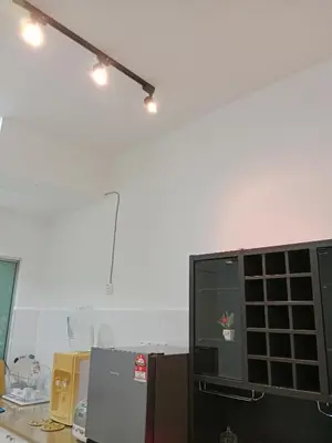 a room with a white wall and a tv and lights at Skyline Nest Crystal Creek in Taiping