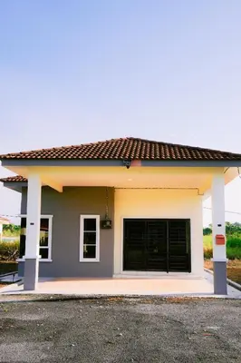 a small house with a garage at Wewe Homestay in Kampung Gajah