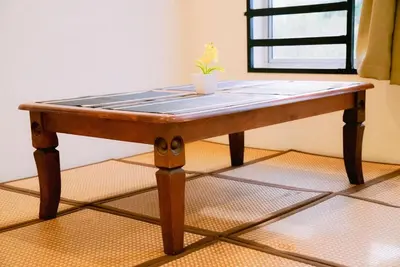 a wooden table with a potted plant on top of it at Wewe Homestay in Kampung Gajah
