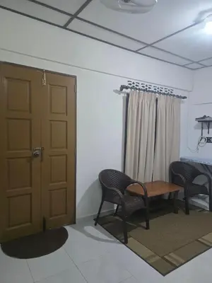a room with a door and two chairs and a table at D Tasek Homestay Lenggong