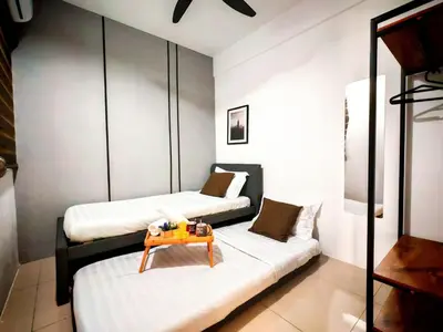 a room with two beds and a table on a couch at Ipoh Manhattan Waterpark 3BR Suite by City Home Empire MHB509 in Ipoh