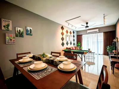 a dining room with a table with plates and hats on it at Ipoh Manhattan Waterpark 3BR Suite by City Home Empire MHB509 in Ipoh
